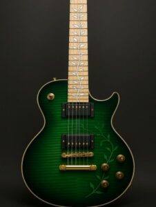 Electric guitar with vine inlays on the fretboard, a green burst body finish, and aged brass hardware.