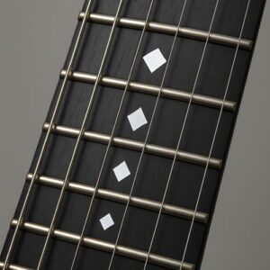 Ebony fretboard with minimalist diamond-shaped inlays arranged along the frets.