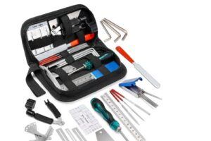 Guitar repair and setup tool kit with 25 pieces, including files, hex wrenches, string action ruler, screwdrivers, feeler gauges, and other luthier tools neatly arranged in a black zippered case on a white background.