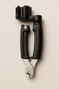 D’Addario Pro-Winder guitar string winder and cutter on a plain background.