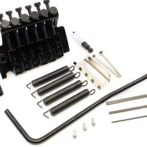 Black Gotoh Floyd Rose–style tremolo system with springs, claw, tremolo arm, hex wrenches, and mounting hardware arranged on a white background.