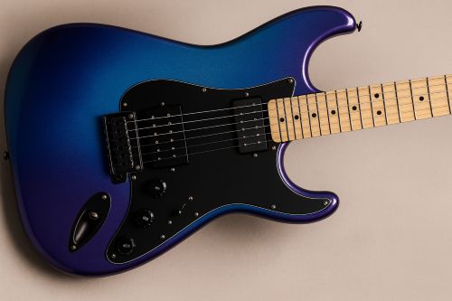 Electric guitar with a blue-to-purple iridescent finish, black pickguard, dual humbuckers, and maple fretboard photographed from a top angle with corrected shadows on a neutral background.