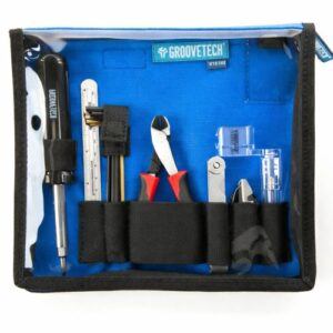 GrooveTech guitar setup tool kit in a blue zippered pouch with organized luthier tools on a white background