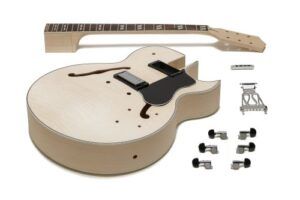Unassembled ES-style semi-hollow DIY guitar kit showing the flame maple body, set neck, pickups, tuners, bridge, and tailpiece laid out on a white background.