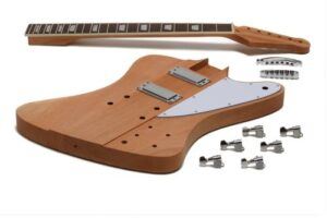 Unassembled Firebird-style DIY electric guitar kit showing the unfinished body, bolt-on neck, chrome mini-humbuckers, pickguard, bridge, and tuning machines laid out on a white background.