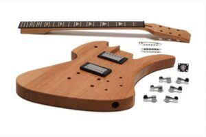 Unassembled Solo MBK-1 DIY electric guitar kit shown on a white background, featuring a mahogany double-cut body, bolt-on neck with inlays, two humbuckers installed, and hardware pieces laid out beside it.