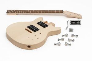 Unassembled Solo PRK-0T electric guitar kit displayed on a white background, featuring a natural wood LP-style body with dual humbuckers, a separate maple neck, chrome tuners, bridge, tremolo components, and hardware laid out neatly.