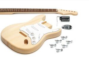 Unassembled Strat-style DIY guitar kit displayed on a white background, featuring a natural wood body with pickguard installed, maple neck, tremolo bridge, jack plate, tuners, and hardware laid out neatly.