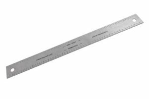Solo Guitars string spacing ruler used for measuring and setting even guitar string spacing on a white background