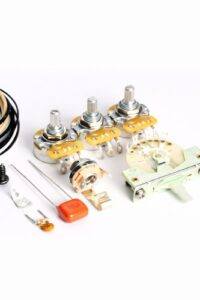 Fender Stratocaster SSS guitar wiring kit showing blender pot, control pots, 5-way selector, and electronics