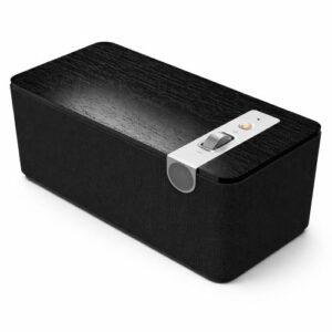 Black rectangular Bluetooth speaker with a dark wood top, black fabric body, and brushed aluminum volume control, photographed on a clean white background.